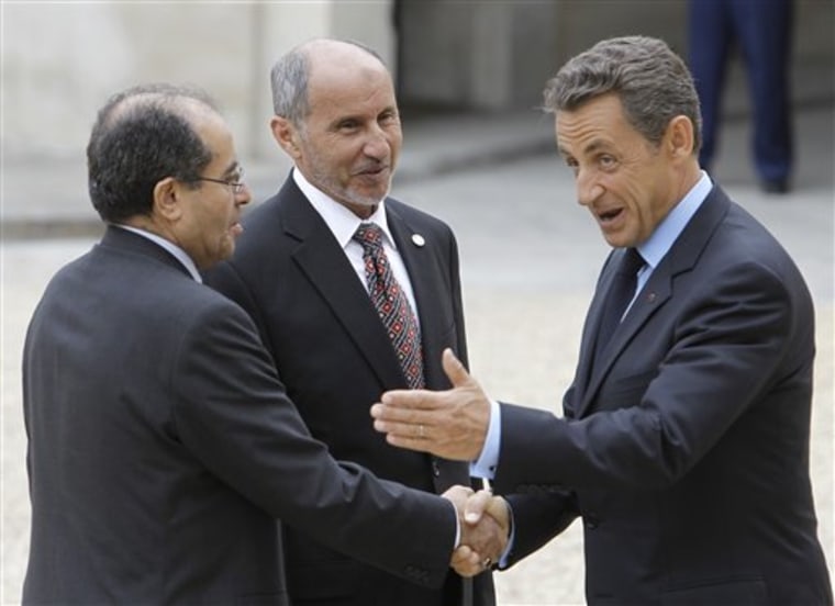 French President Nicolas Sarkozy, right, welcomes Libyan National Transitional Council chairman Mustafa Abdel Jalil, center, and Libyan Transitional National Council Prime Minister Mahmoud Jibril, left, at the Elysee Palace in Paris, on Thursday.